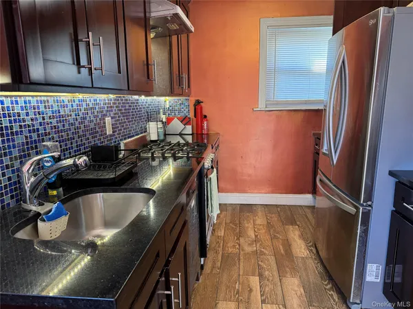 a kitchen with a sink appliances and cabinets