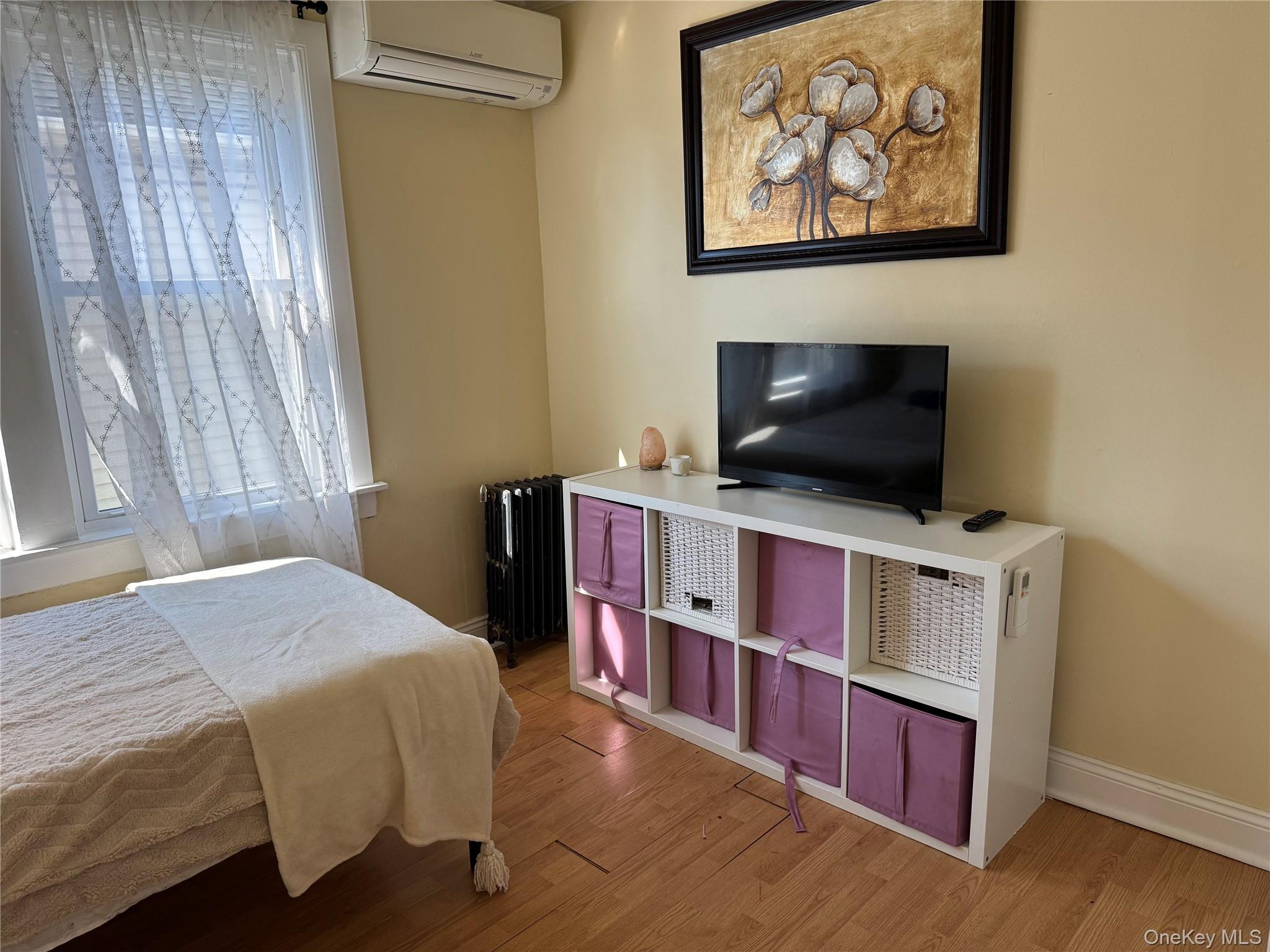 26 Parkside Drive Jericho, NY 11753 - Photo 18 of 25 a bedroom with a bed and a flat screen tv