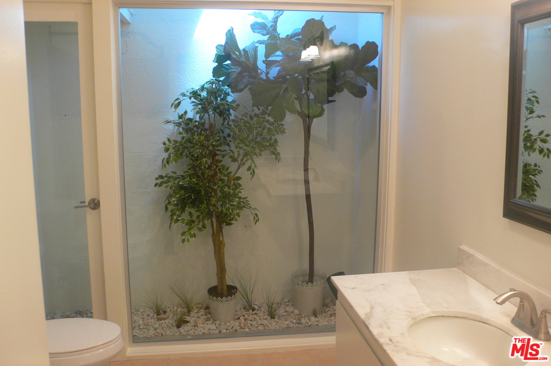 2101 Roscomare Road Los Angeles, CA 90077 - Photo 5 of 8 a vase of flowers sitting on a table