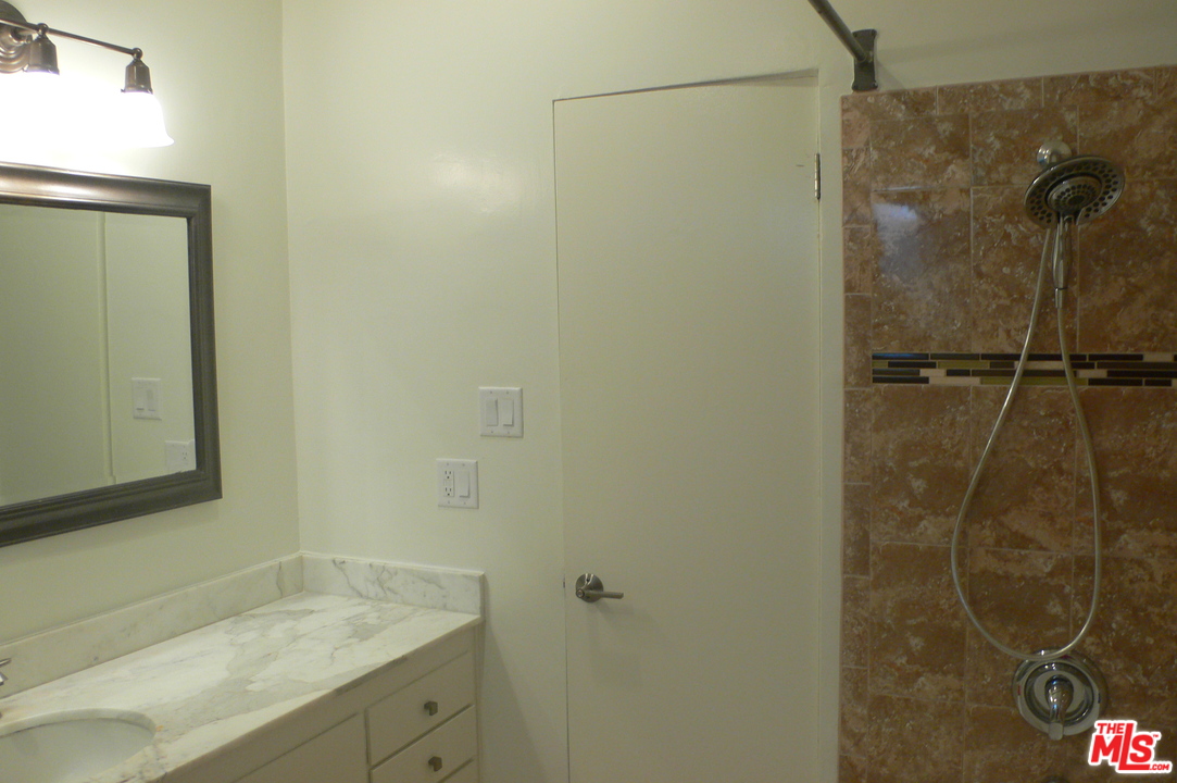 2101 Roscomare Road Los Angeles, CA 90077 - Photo 6 of 8 a bathroom with a shower and a sink
