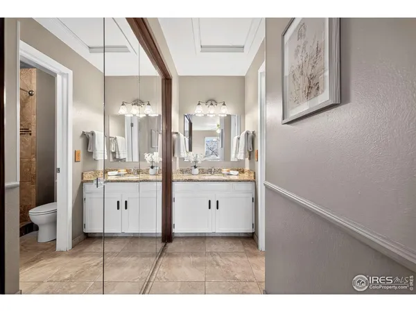 a bathroom with a sink and mirror with toilet
