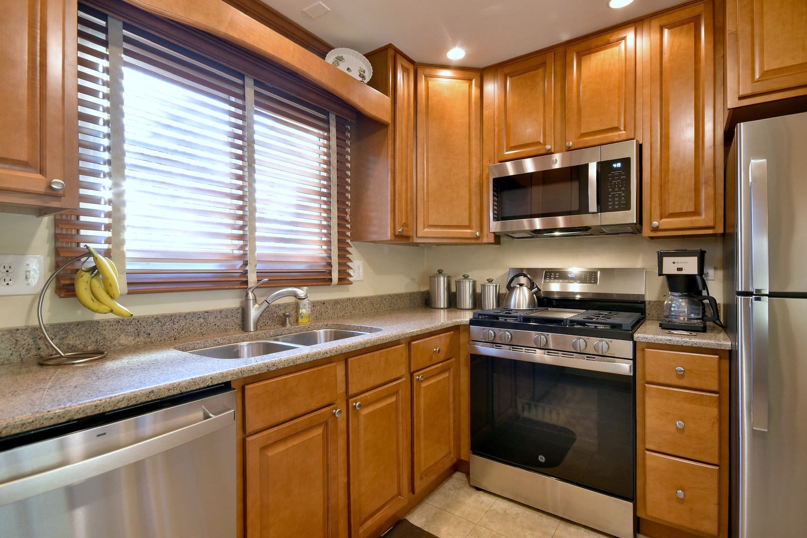 1652 Dover Court, Unit B Wheaton, IL 60189 - Photo 9 of 29 a kitchen with stainless steel appliances granite countertop a sink a stove and cabinets