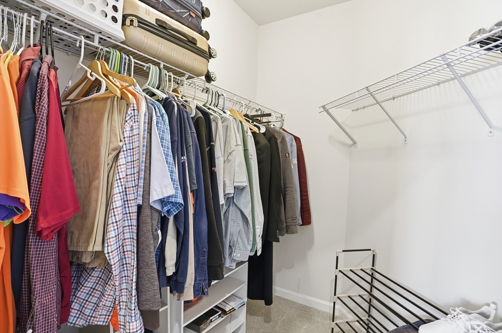 2306 Talbot Way, Unit 2306 Westborough, MA 01581 - Photo 16 of 37 a view of walk in closet with clothes and shoes