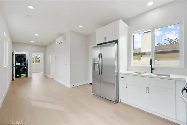 a kitchen with stainless steel appliances a refrigerator and a sink