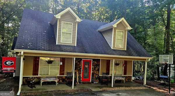 a view of a house with a yard and sitting area