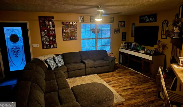 a living room with furniture and a flat screen tv