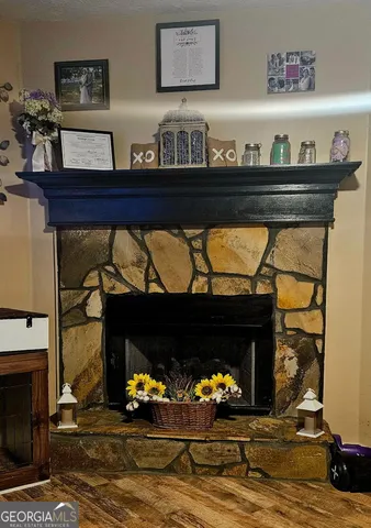 a living room with fireplace furniture and a fireplace