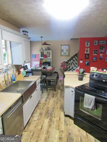 a kitchen with a stove and cabinets