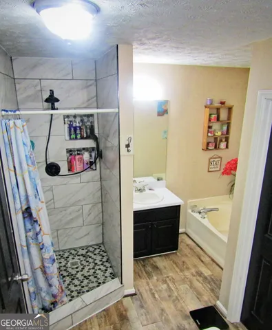 a bathroom with a bathtub and shower