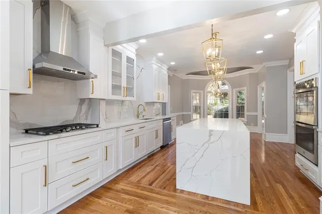 a view of empty room with wooden floor and windows