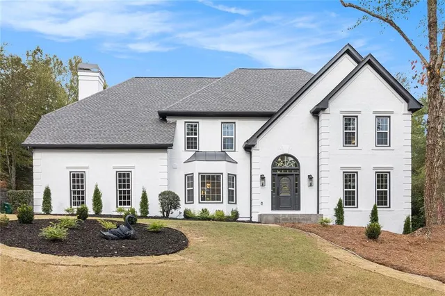a front view of a house with garden