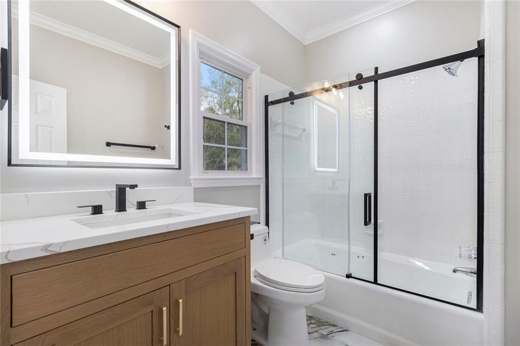2820 Harwick Drive Atlanta, GA 30350 - Photo 22 of 48 a bathroom with a sink a toilet and shower