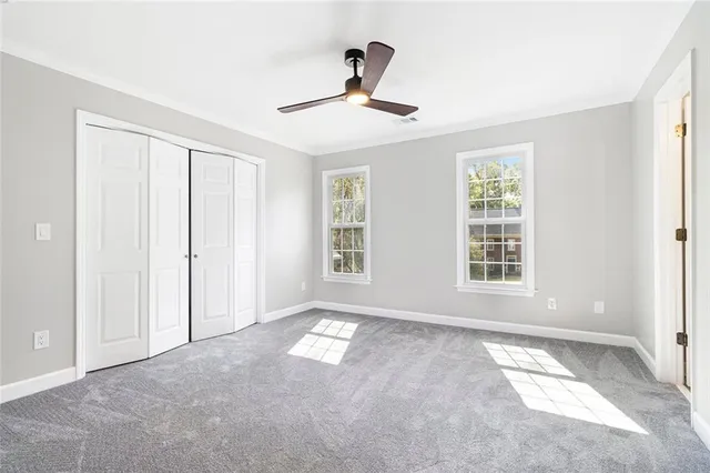 a view of an empty room with a fireplace and a window