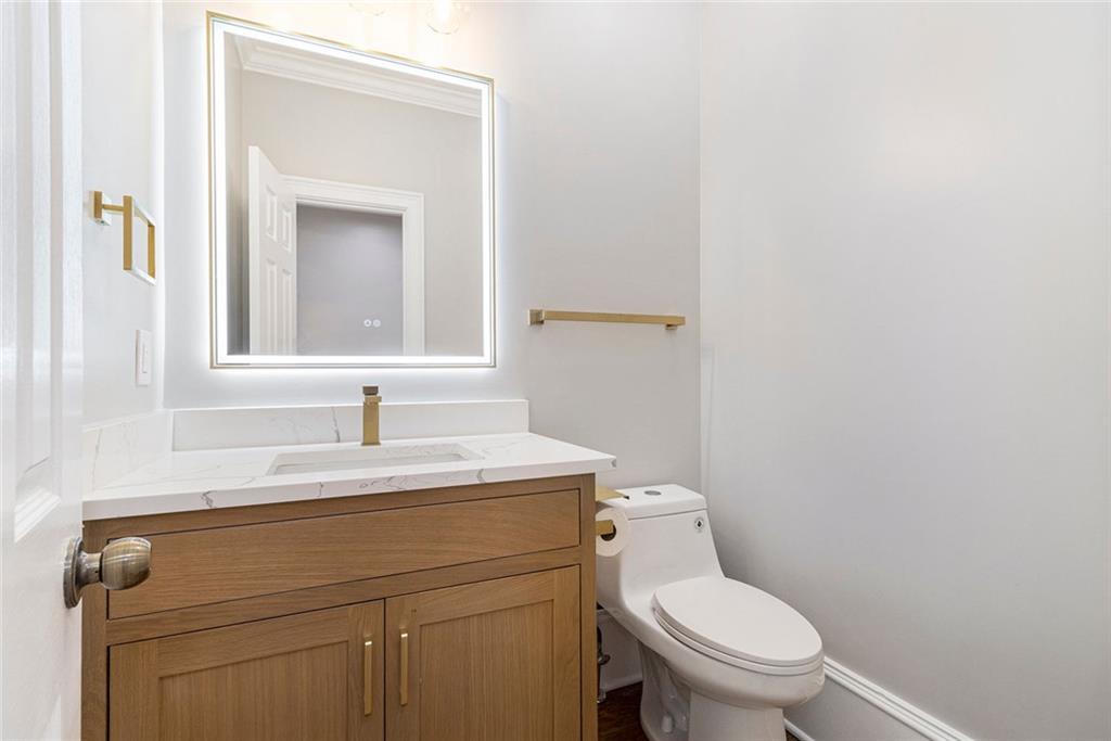 2820 Harwick Drive Atlanta, GA 30350 - Photo 31 of 48 a bathroom with a toilet sink vanity and mirror