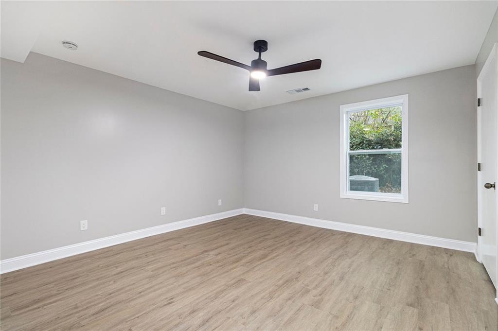 2820 Harwick Drive Atlanta, GA 30350 - Photo 32 of 48 an empty room with wooden floor and windows