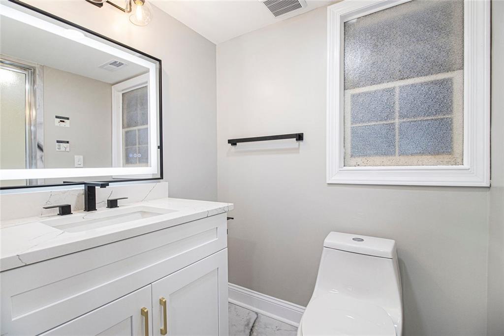 2820 Harwick Drive Atlanta, GA 30350 - Photo 38 of 48 a bathroom with a toilet sink and mirror