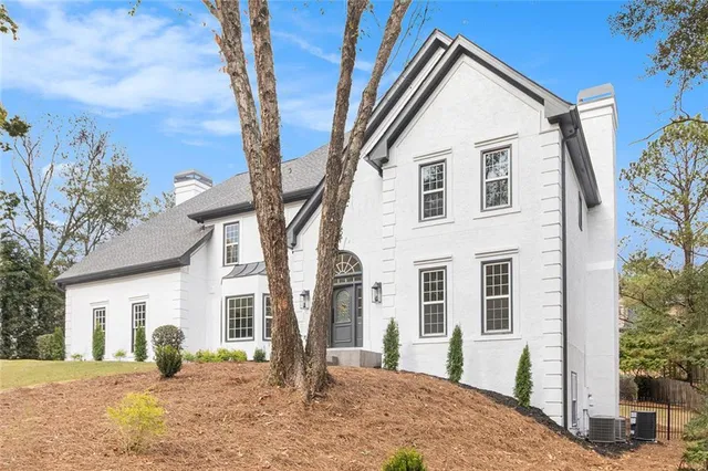 a front view of a house with a yard outdoor seating and pathway