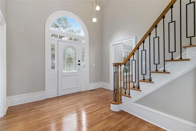 a view of an entryway with wooden floor