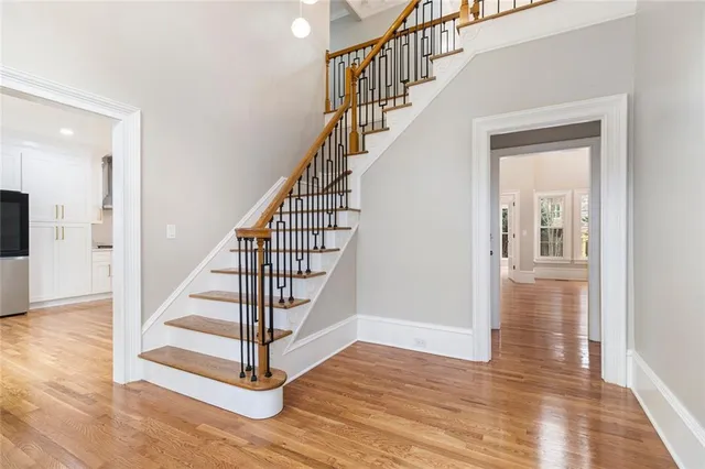 a view of entryway and hall with wooden floor
