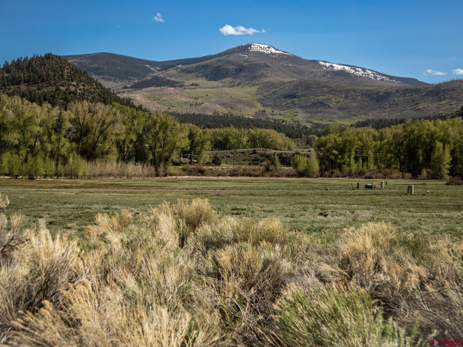 127 Browns Road South Fork, CO 81154 - Photo 14 of 44 a view of a town with mountains in the background