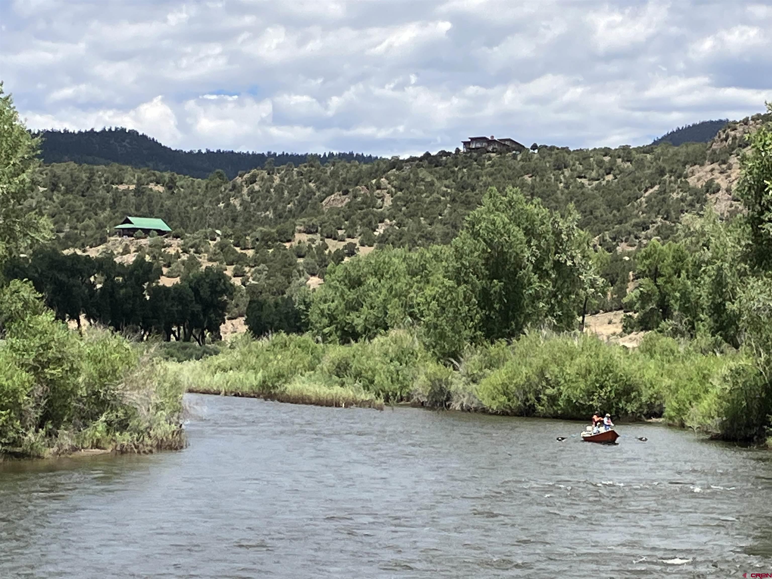 127 Browns Road South Fork, CO 81154 - Photo 29 of 44 a view of a lake with a building in the background