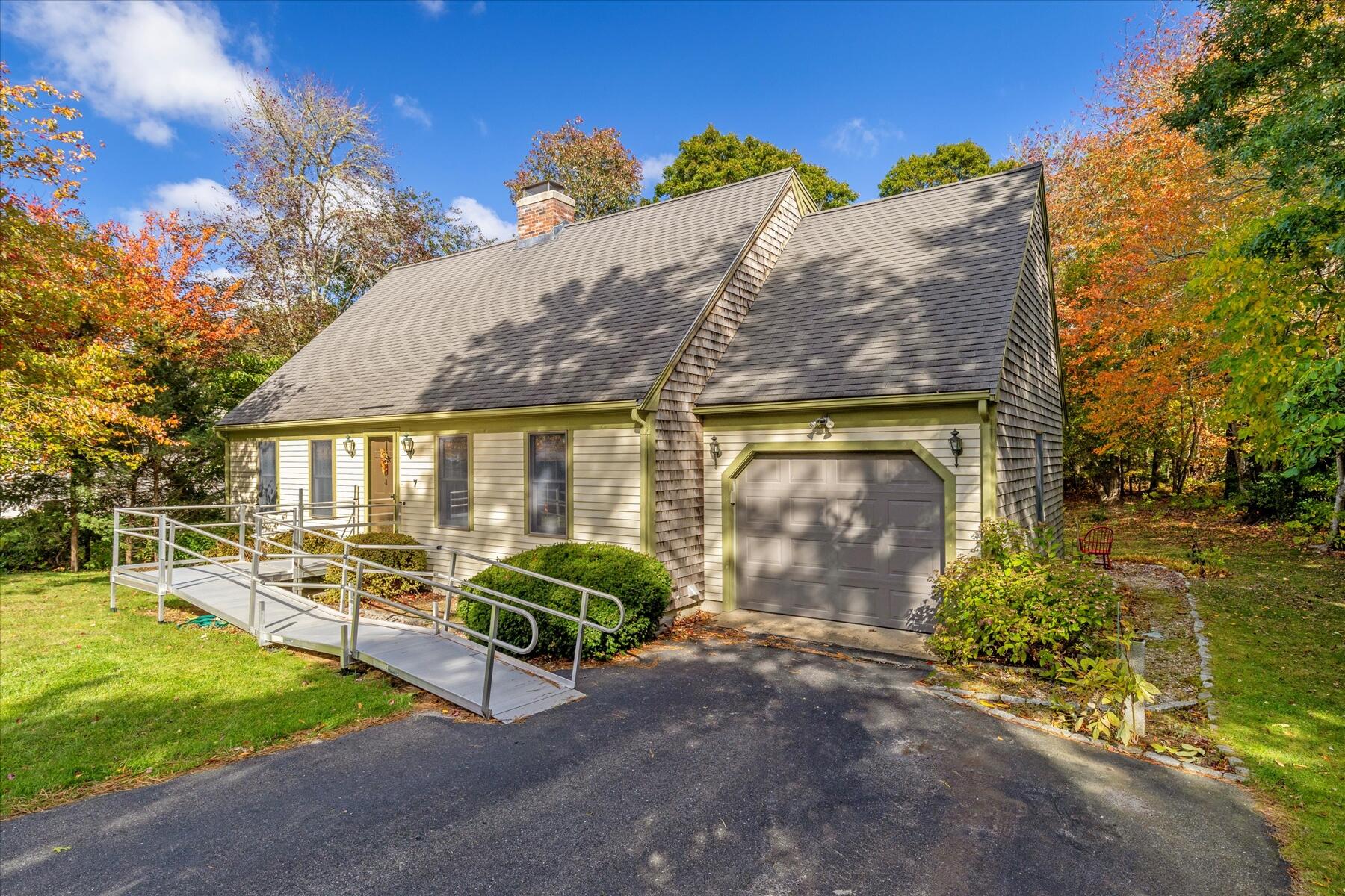 7 Sandy Way Mashpee, MA 02649 - Photo 2 of 41 a view of a patio with a table and chairs under an umbrella