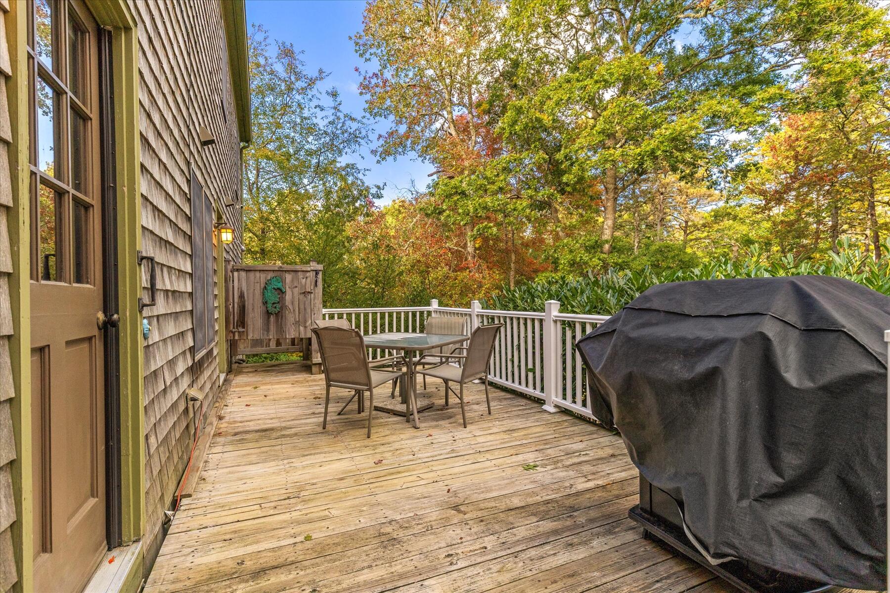 7 Sandy Way Mashpee, MA 02649 - Photo 27 of 41 a view of a roof deck with table and chairs and wooden floor