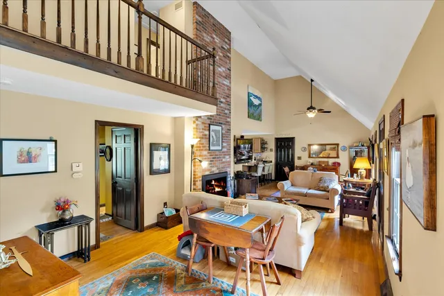 a living room with fireplace furniture and a wooden floor