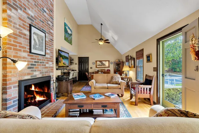 a living room with furniture fireplace and flat screen tv