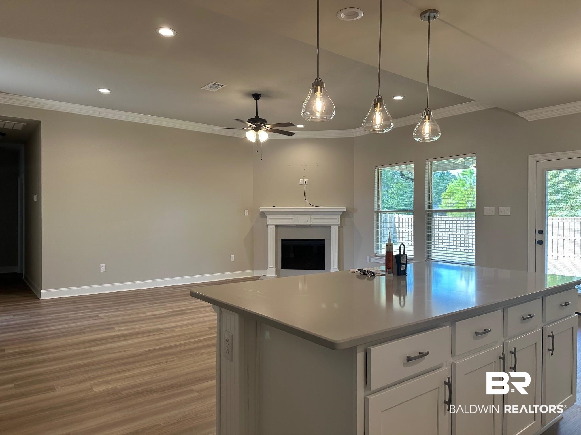 1009 Ruisseau Drive Foley, AL 36535 - Photo 30 of 55 Kitchen featuring a center island, hanging light fixtures, ceiling fan, white cabinets, and dark wood-type flooring