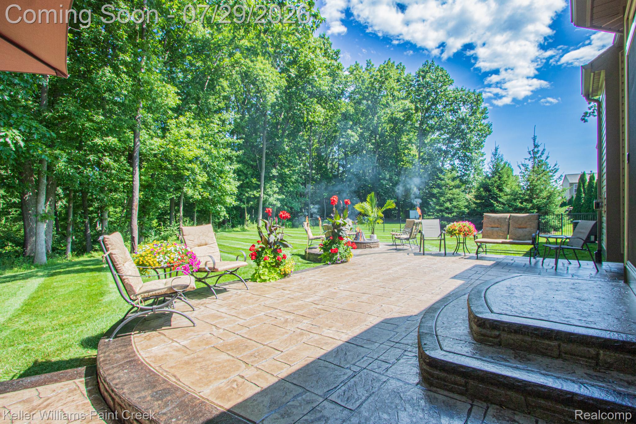 49118 Ridgeview Drive Macomb, MI 48044 - Photo 41 of 57 Expansive stamped concrete patio with stone-accented steps