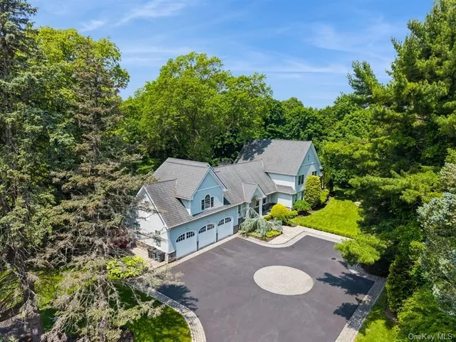 an aerial view of a house with yard swimming pool and outdoor seating
