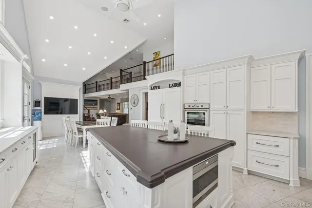 a kitchen with kitchen island a stove a sink and a refrigerator