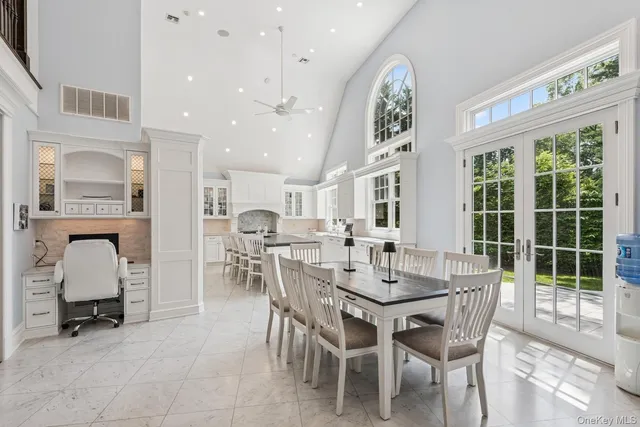 a dining room with furniture and a large window