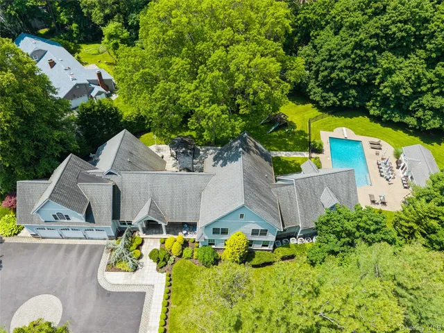 an aerial view of a house with swimming pool and big yard