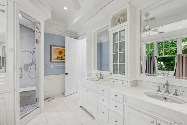 a spacious bathroom with a shower sink and mirror