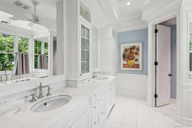 a bathroom with a tub sink and mirror
