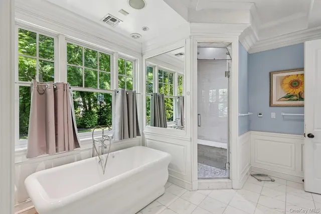 a bathroom with a tub and a shower