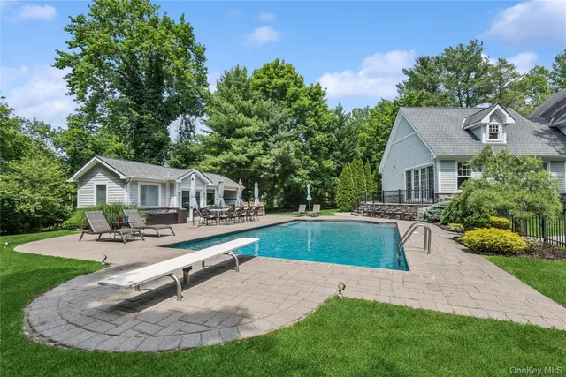 a view of a house with a patio and a yard