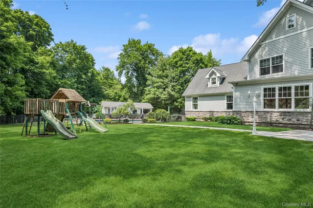 a view of a house with backyard and sitting area