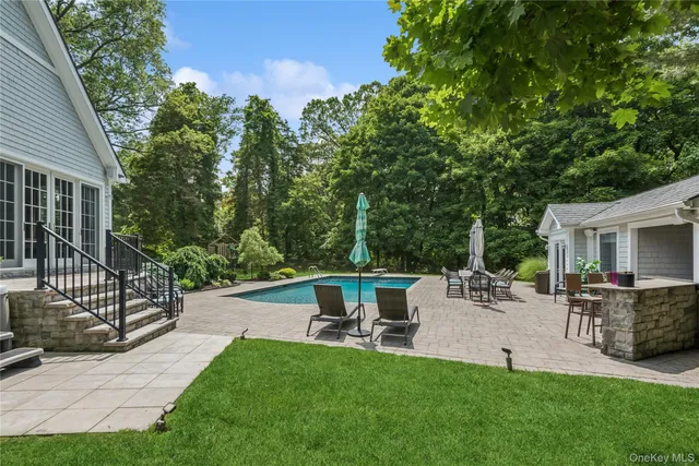 a view of backyard with seating area and green space