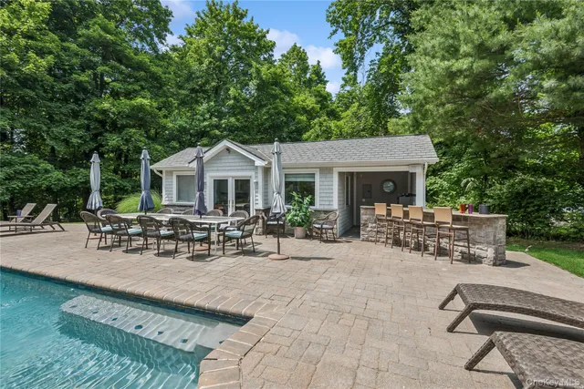 a view of house and a dinning table and chairs in patio