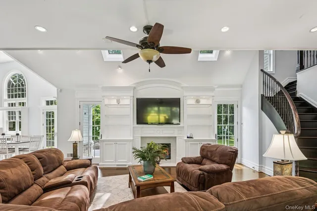 a living room with furniture a fireplace and a flat screen tv