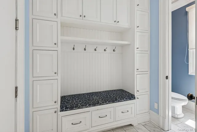 a room with white cabinets and a refrigerator
