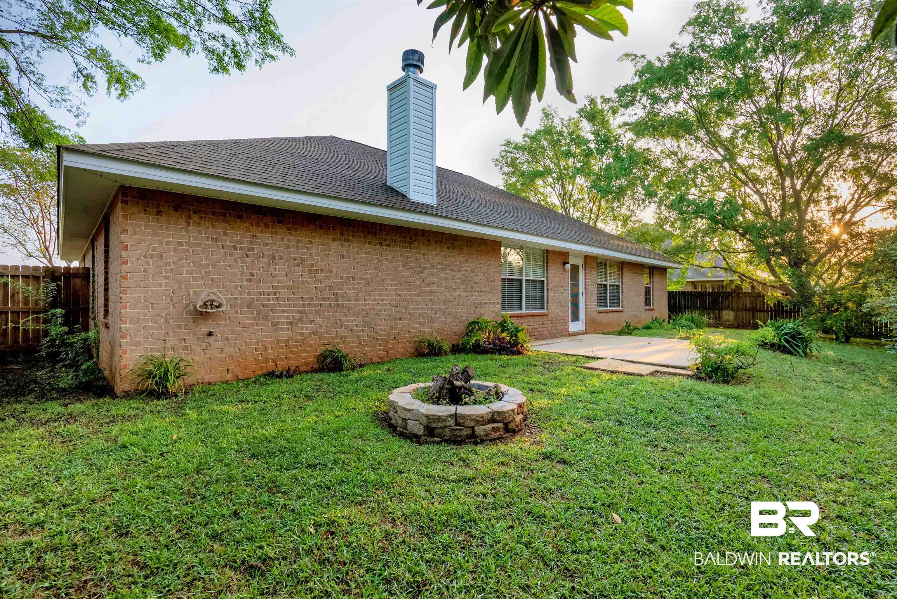 165 Pemberton Loop Fairhope, AL 36532 - Photo 21 of 25 Back of property featuring fence, a patio, a chimney, an outdoor fire pit, and a yard