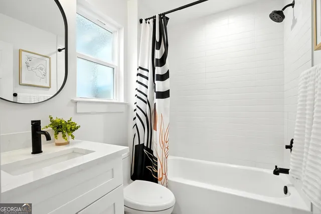 a bathroom with a sink a toilet and a bathtub