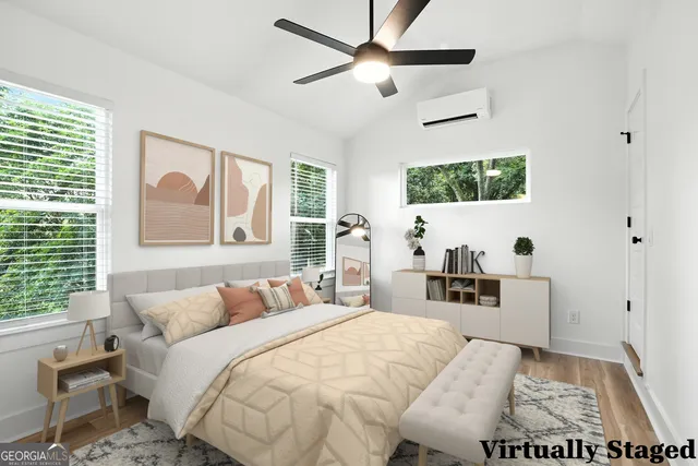 a bedroom with a large bed and a flat screen tv