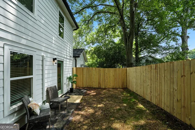 a view of a backyard with chairs