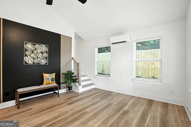 a wooden bench sitting in a living room next to a window