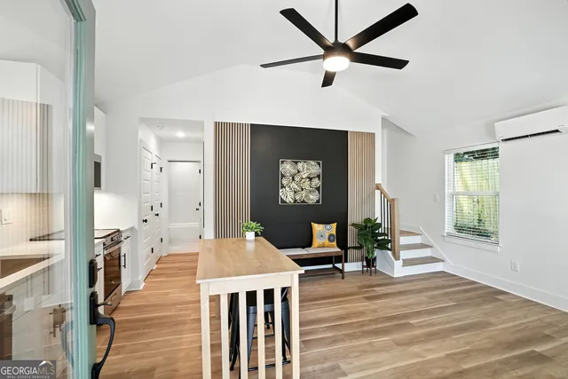 a living room with furniture wooden floor and a window